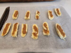 Banana boats on parchment paper filled with chocolate